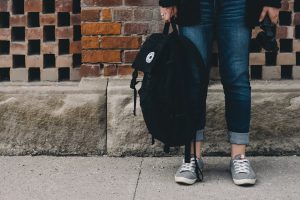 leaving for school person standing near brown concrete wall